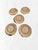 A quietly sculptural set of five Japanese studio pottery plates, each hand-thrown in warm, sandy-toned stoneware and...