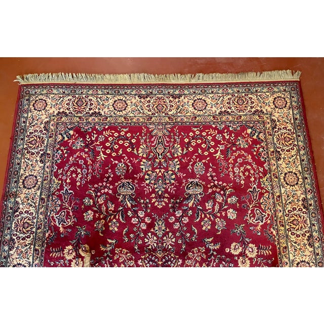 Hand-knotted rug measuring 2M13 by 2M02 with red decoration.
