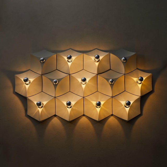 A modular wall installation of 13 sconces, produced by Hoffmeister in Germany during the 1960s. Each fixture is formed in...