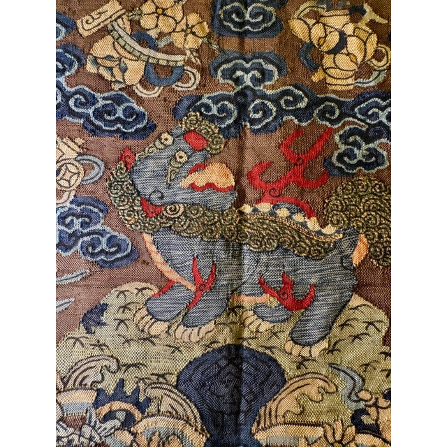 A rare Qing dynasty military mandarin square, stitched in painstaking petit point on silk gauze. A blue lion, the emblem...