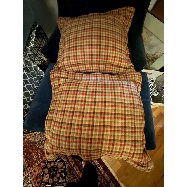 Beautiful custom king bedding ensemble featuring a quilted neutral coverlet, coordinating plaid shams and bed skirt, and...