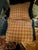Beautiful custom king bedding ensemble featuring a quilted neutral coverlet, coordinating plaid shams and bed skirt, and...