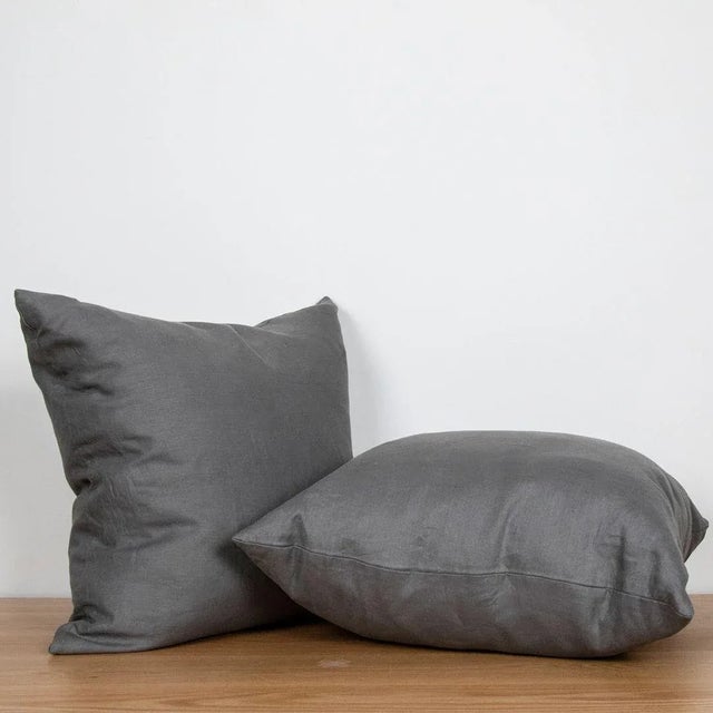 Square linen pillow with zipper closure.