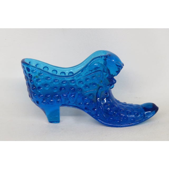 This gorgeous figurine is made out of glass. This wonderful piece is a depiction of a Victorian style shoe in a marvelous...