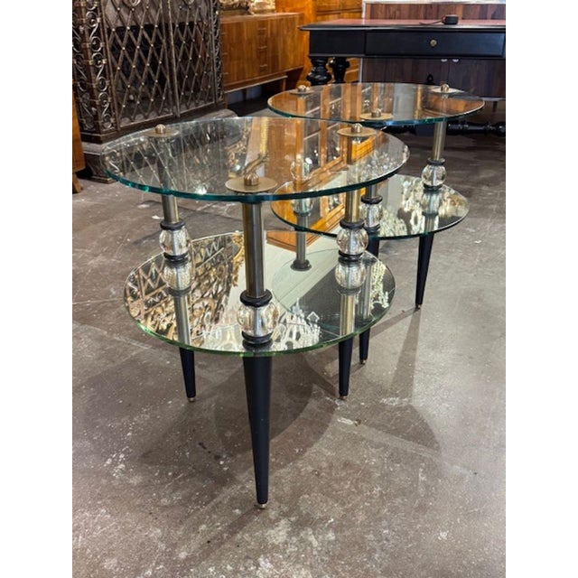 The product is a pair of vintage brass and steel Semon Bache side tables from New York city. These tables feature brass...