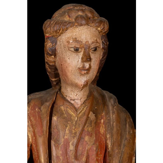 A rare Spanish Gothic polychrome wood sculpture depicting Saint Margaret of Antioch, dating from the 16th century and...