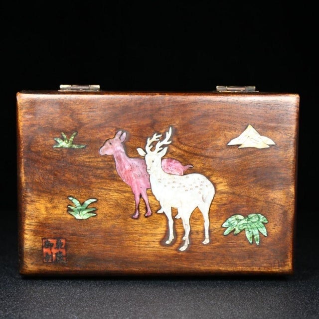 Handcrafted solid huali wood jewelry box decorated with intricate mother-of-pearl shell marquetry on the lid. The inlay...