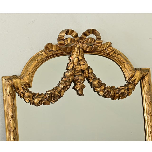 Dimensions: 64 ¼” H x 21 ½” W x 2 ¾” D A lovely gilt mantel mirror from 19th century France, the narrow proportions of the...