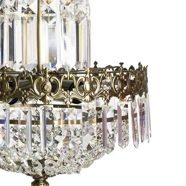 A tapered crystal chandelier in cognac coloured brass with hand cut crystals. Three rings of various diameter that tapper...