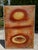 Original mixed-media relief artwork by Florida artist Katherine Boren, featuring a richly textured surface in warm rust,...