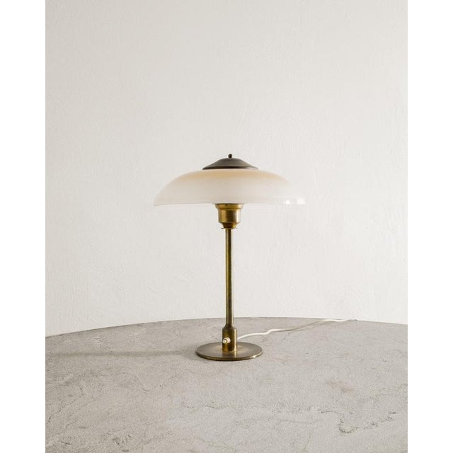 Rare Danish mid century desk table lamp in patinated brass with a frosted yellow white opaline glass shade produced by Fog...