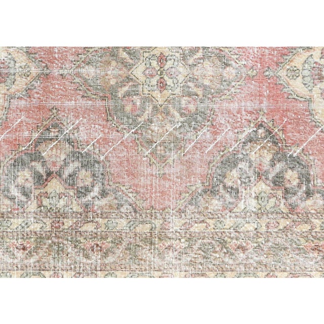 Originating from the storied Oushak weaving centers of Western Turkey, this vintage rug represents generations of...