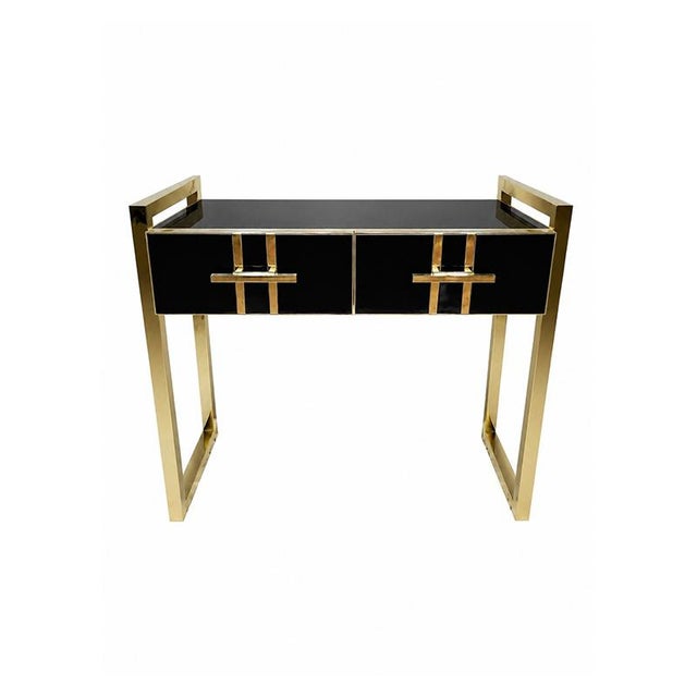 Console entirely handcrafted, with a wooden structure covered in black glass. Enriched with a tubular brass frame....