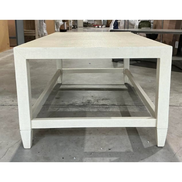 This elegant shagreen coffee table features a clean, rectangular silhouette with a sophisticated off-white finish. The...