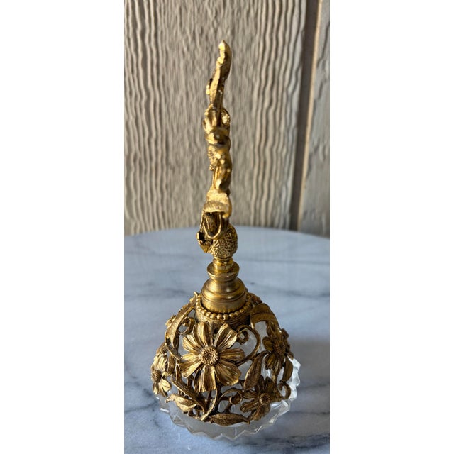 ## Description This mid-century Hollywood Regency perfume bottle by Matson features an intricate 24K gold-plated brass...