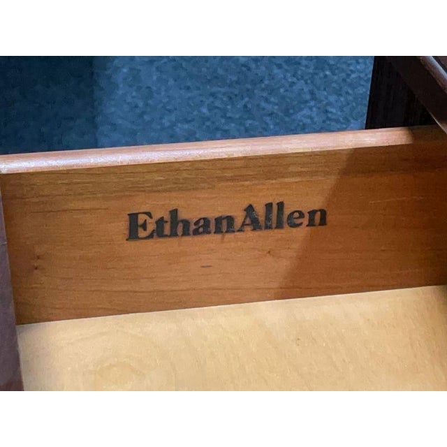 Ethan Allen cherry console table featuring four dovetailed drawers with original brass bail pulls. The table has a...