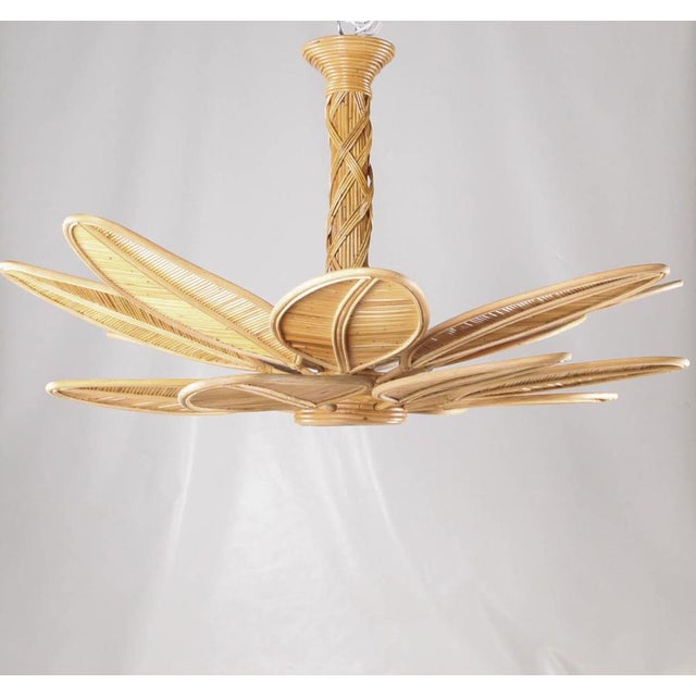 Incredible rattan chandelier composed of a central trunk with interwoven rattan and numerous leaves that attach to the...