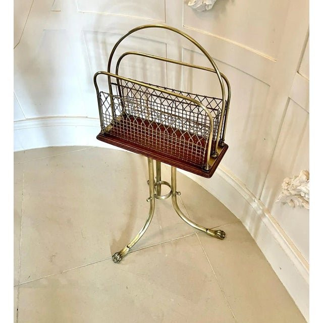Quality antique victorian brass and mahogany revolving magazine stand having a shaped brass handle to the centre, two...