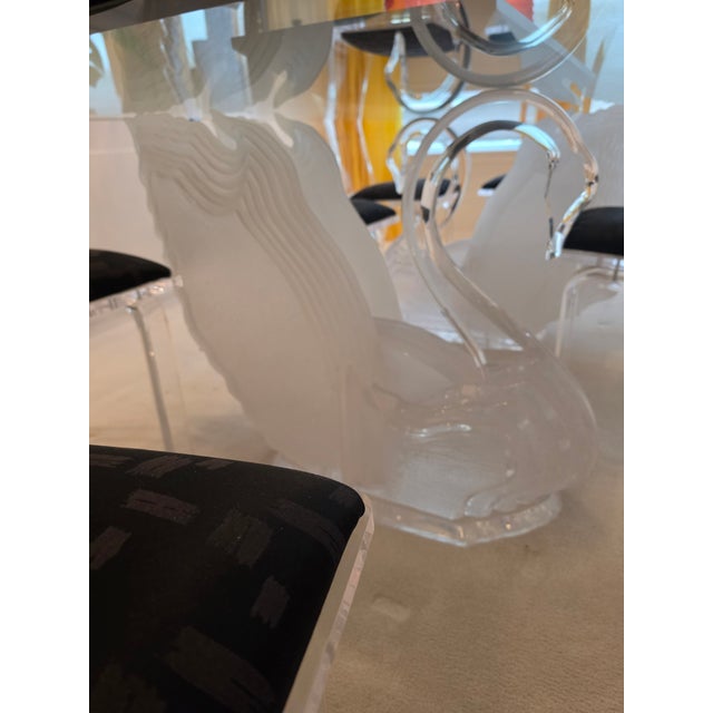 Made by Sharooz Nia in the 1990s. Glass and Lucite with swan bases. 8 acrylic chairs with black fabric seats