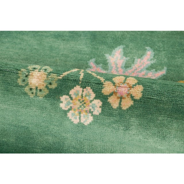 Hand-knotted in wool, this 4x6 contemporary Chinese Deco rug showcases a radiant jade-green field enclosed by sculpted...