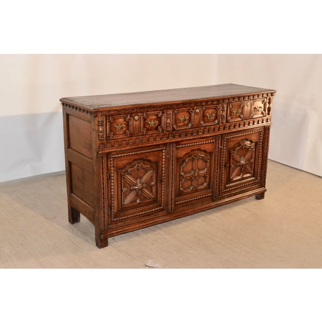 18th century English oak dresser base with a two plank top which has a beveled edge, following down to wonderful dentil...