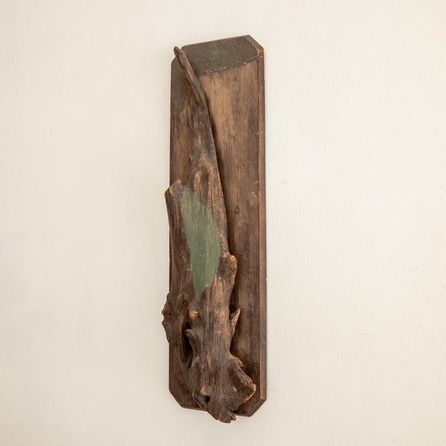 Sculptural wood relief evoking a woodland setting.