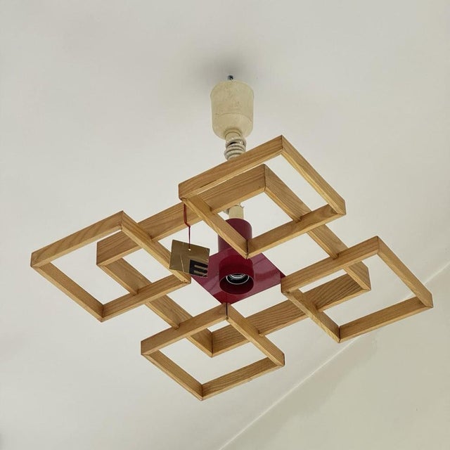 Angelo Brotto Esperia Pendant Lamp MOD. Amelio 1960's. Wooden structure, lamp holder in red enamelled metal. The item is...