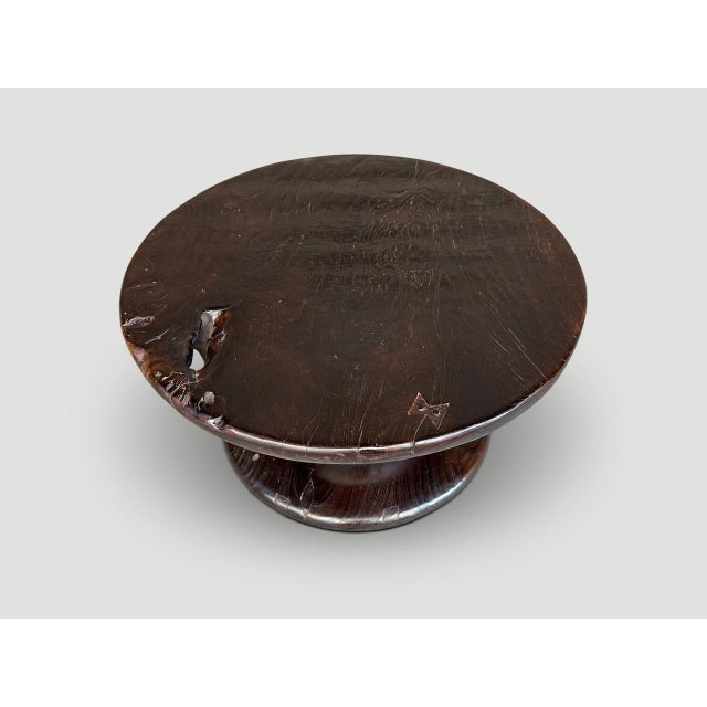 Impressive side table hand carved from a single piece of century old teak wood. We added an espresso stain and a polish...