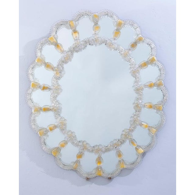 This beautiful oval shaped Venetian mirror features etched floral motifs adorning the mirrored frame. Along the edges of...
