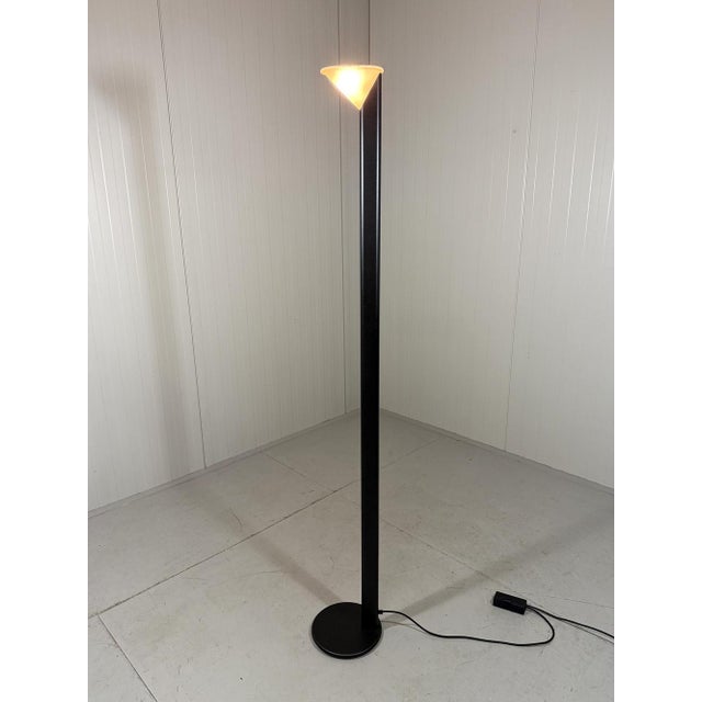 Floor lamp by Arelux Milano, Italy (marked). Minimalist design. Black stand with a small white glass lampshade. Halogen,...