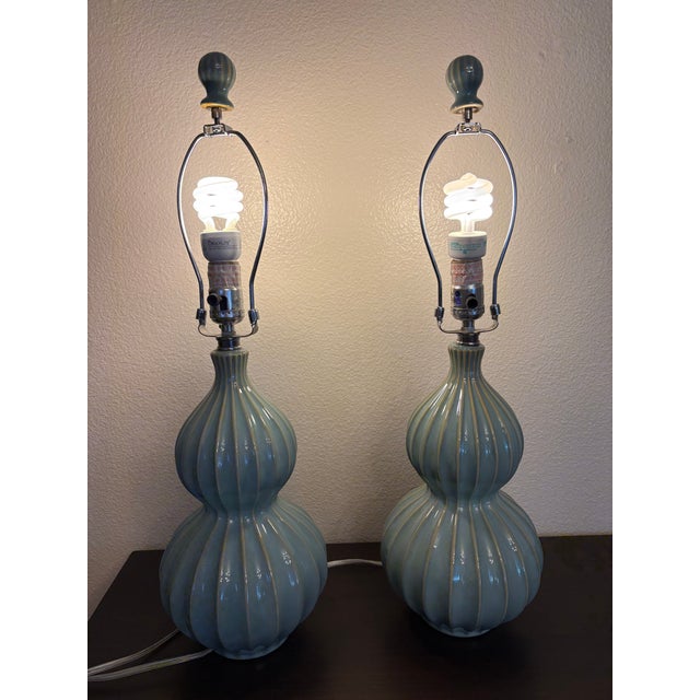There is a three way lights on these ribbed French blue stacked ball lamps that radiate a beautiful golden light for any...