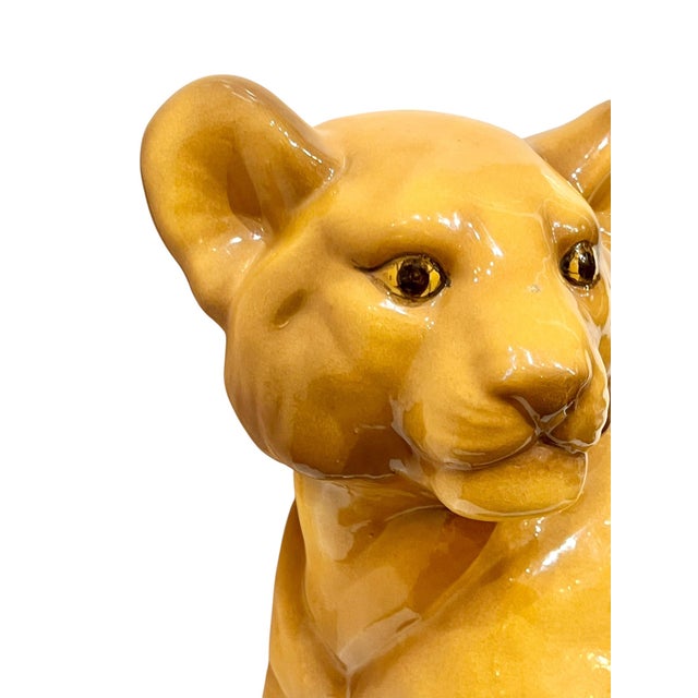 Charming larger size ceramic hand painted lion cub. Has a sweet face with hand painted brown eyes. Light tan color.