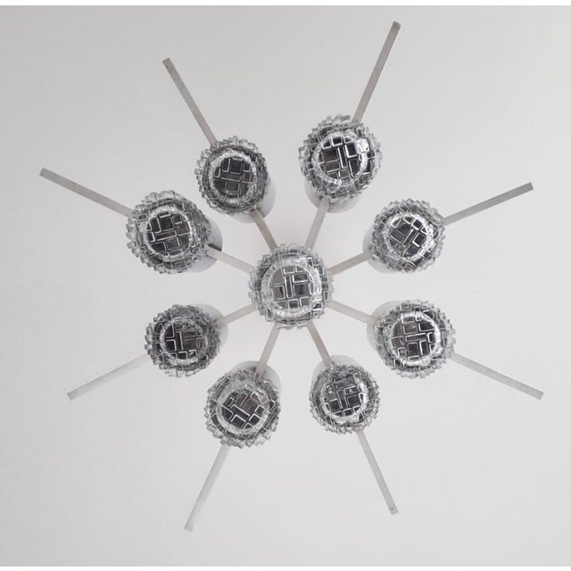 Striking vintage Italian chandelier designed by Gaetano Sciolari, circa 1970's. This sculptural fixture features nine...