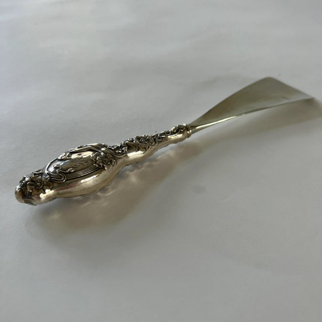 This exquisite sterling silver shoehorn is rendered in the classic art nouveau style: the handle features the long sinuous...