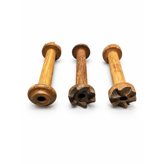 A charming set of three antique solid wood textile mill bobbins dating from the late 19th to early 20th century, circa...