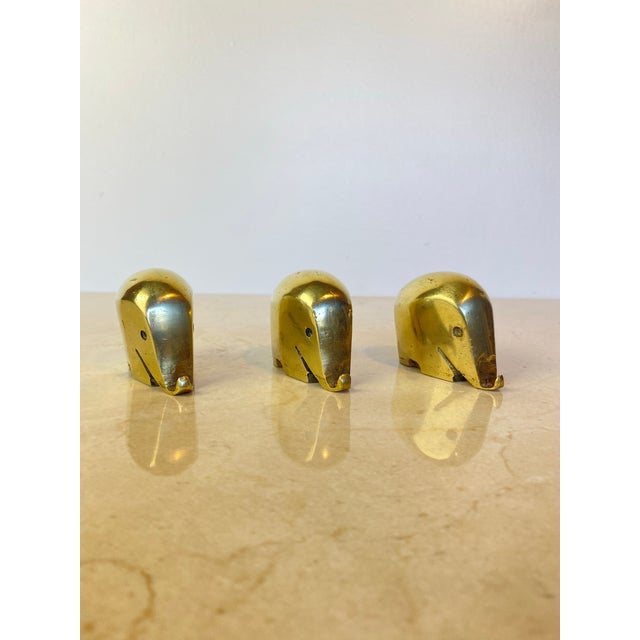 Set of three vintage solid brass elephant paperweights, known as "Drumbo," produced as an exclusive gift by Dresdner Bank...