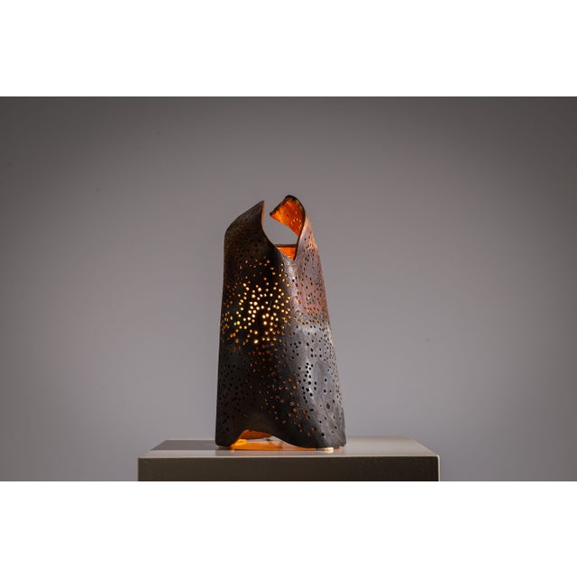 This vintage ceramic table lamp is a sculptural piece of art that merges organic form with atmospheric lighting. Crafted...