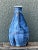 Crafted with expressive artisan technique, this vintage studio pottery vase features a tapered bottle silhouette with a...