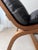 Mid-century armchair from the 1970s, constructed from carefully curved plywood and upholstered in supple black leather....