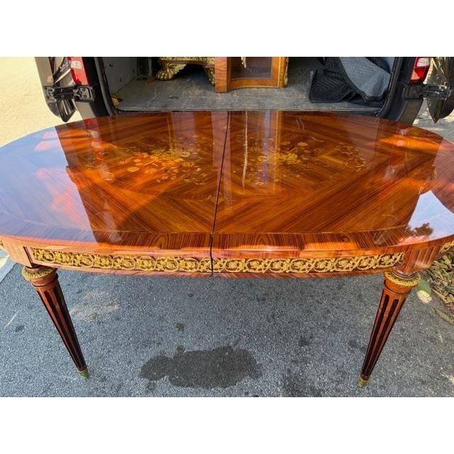 Description This is a very Fine French Mid Century Louis XVI Style Marquetry Inlaid Dining Table with Inset Ormolu Mounts....