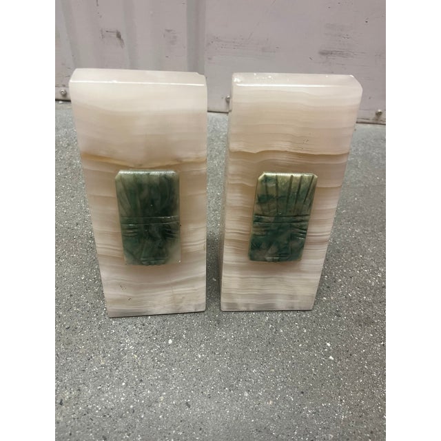 6” tall, 3” wide and approximately 3lbs each. Hand carved pyramidal set of bookends made of a marbled onyx with a tribal...