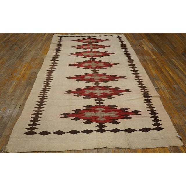 This is an exceptional and highly authentic early 20th-century American Navajo carpet, dating back to circa 1930. Spanning...