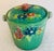 This is a colorful 1930s ceramic Majolica cookie jar with a wicker handle. It is charming and can also be used as an ice...