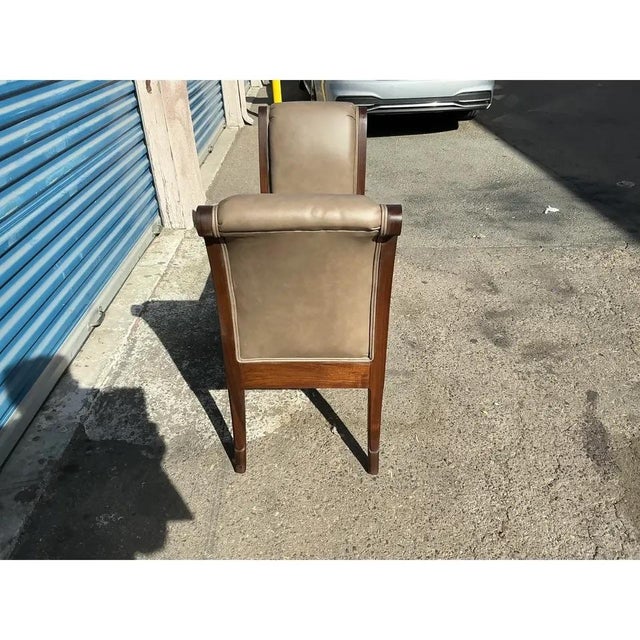 Modern solid walnut Klismos bench. Bench is done in a gray leather. The bench is in excellent condition. The wood and...