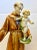 Saint Anthony is holding a cherubic child on his book and is looking at him lovingly. The porcelain has been glazed in...