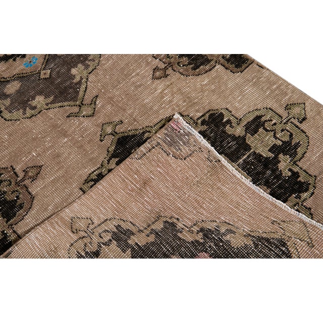 Beautiful antique wool runner rug, hand-knotted wool with a dark tan field, light and dark brown accents in an allover...