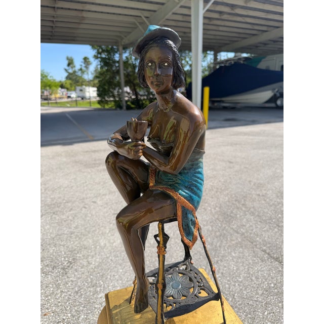 Bronze Statue of a Girl on a Stool Drinking Champaign This is a piece very much in the 1920s style, we have a slightly...