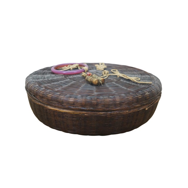 Antique Chinese wicker sewing basket featuring round form with beaded ring and tassel accents. Dimensions: 11" x 3.5"...