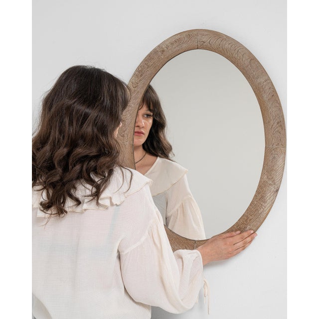 Cerused oval wall mirror in Weathered Whitewash. Finished in weathered whitewash, this cerused oval wall mirror is...