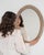 Cerused oval wall mirror in Weathered Whitewash. Finished in weathered whitewash, this cerused oval wall mirror is...
